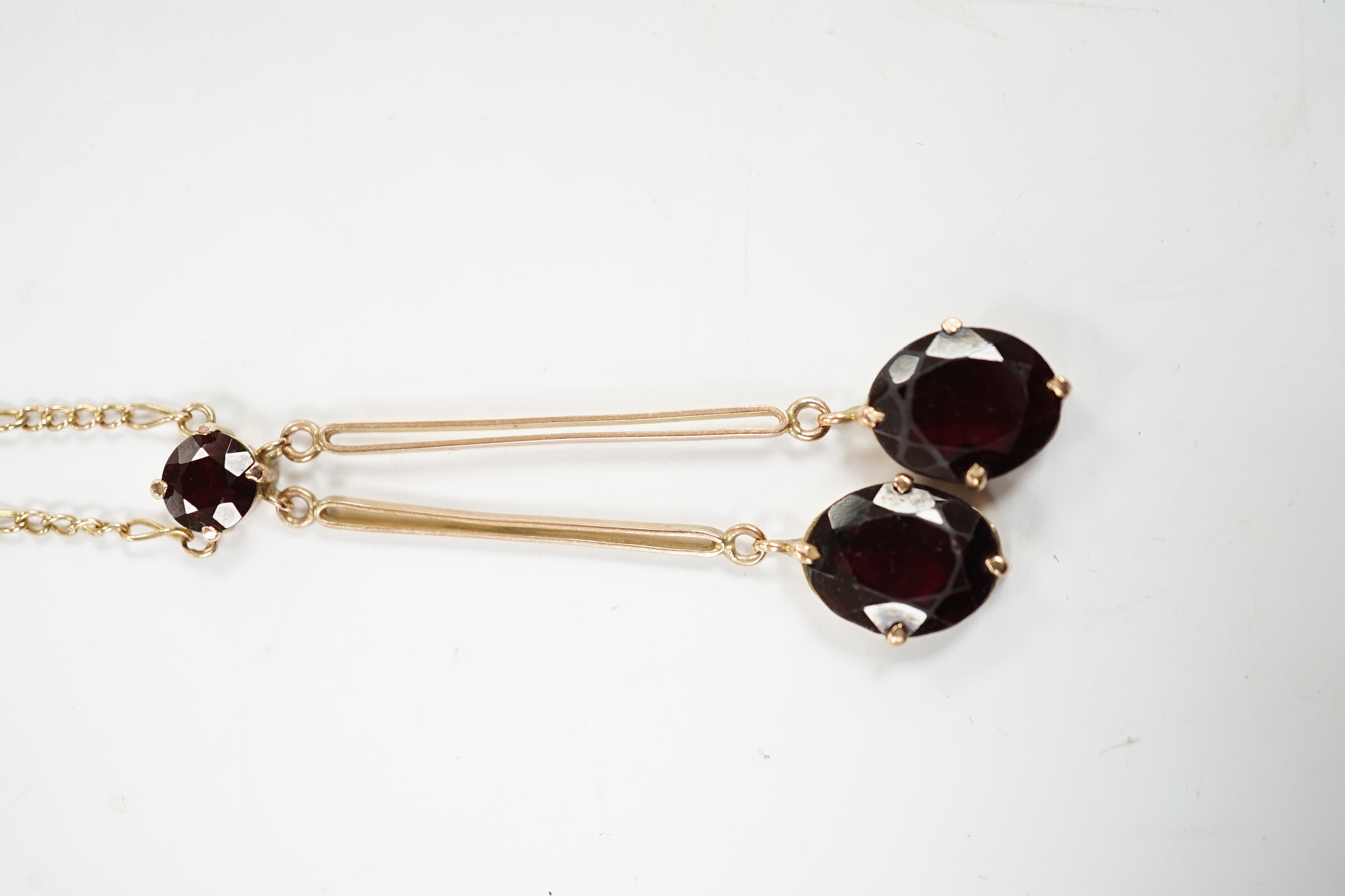 A 9k and three stone garnet set double drop pendant necklace, overall 52cm, gross weight 5.3 grams.